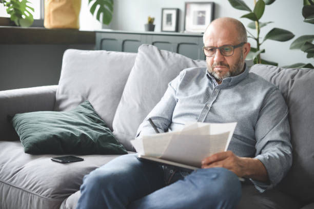 istock mature adult man working from home office (paperwork, negative emotion ) 1319956867