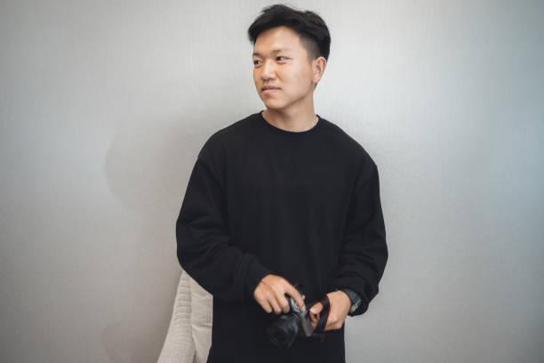 istock A boy with a digital camera in his hand in a clean and tidy environment 1319957505