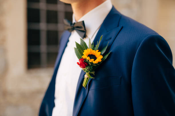 Midsection Of Man Holding Flower  buttonhole flower stock pictures, royalty-free photos & images