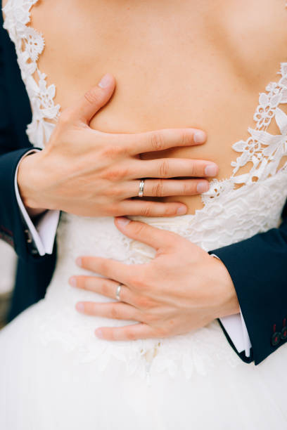 istock Midsection Of Couple Holding Hands 1319957822