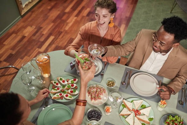 istock Young People Enjoying Dinner Party at Home 1319959426