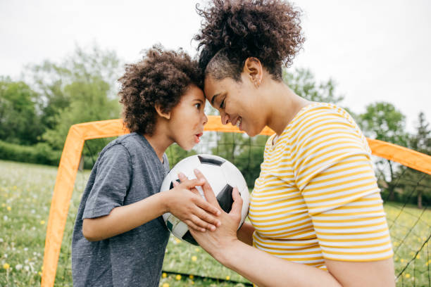 istock Summertime activities for kids and parents - soccer game 1319959607