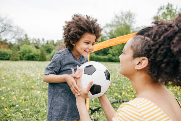 istock Summertime activities for kids and parents - soccer game 1319959614