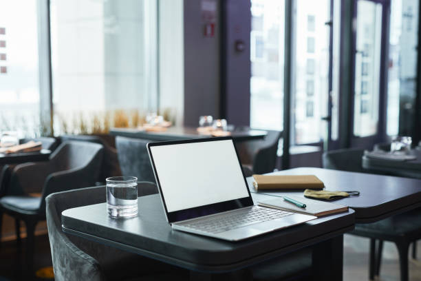 istock Modern laptop and organizer on table in cafe 1319959953