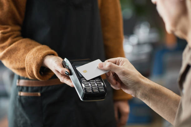 istock Cafe customer paying with credit card with NFC 1319959986
