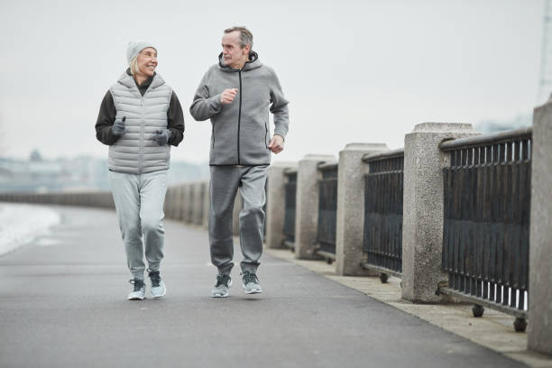 istock Senior joggers running and talking 1319960062