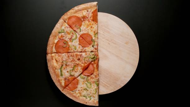 istock Half of Big Pizza on a black background, Top view 1319961244