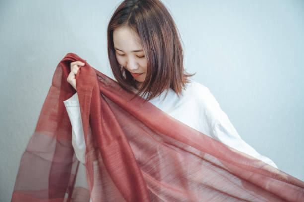 istock A girl wearing a red scarf in a clean and comfortable environment 1319961624