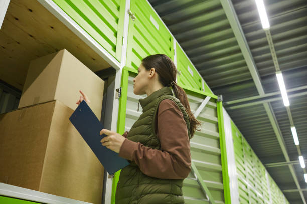 istock Woman packing parcels in storage 1319962094