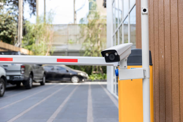 istock Security CCTV camera surveillance system outdoor of carpark. A blurred night city scape background. Modern CCTV camera on a wall. Equipment system service for safety life or asset. 1319962997