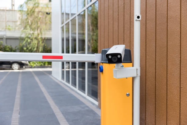 istock Security CCTV camera surveillance system outdoor of carpark. A blurred night city scape background. Modern CCTV camera on a wall. Equipment system service for safety life or asset. 1319963032