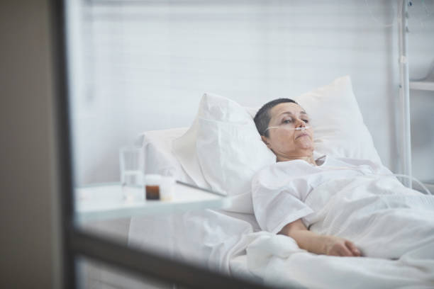 istock Woman lying on hospital bed 1319963396