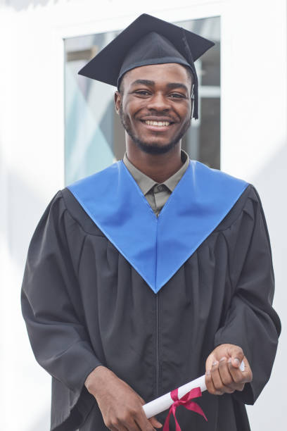 istock Young man in graduation gown 1319965309