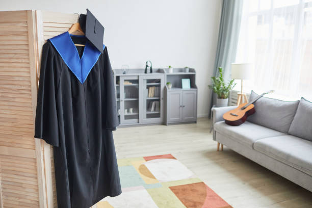 istock Graduation gown on hanger at home 1319965351