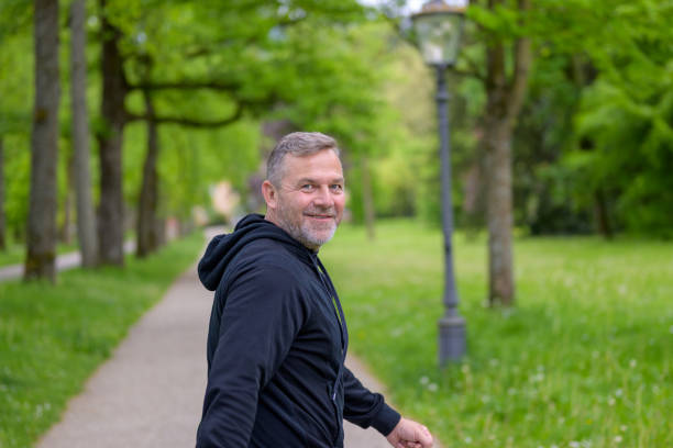 istock Happy friendly man turning to smile at the camera 1319967651