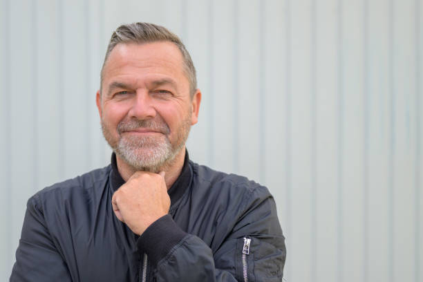 istock Middle aged man raising his hand to his throat 1319968302
