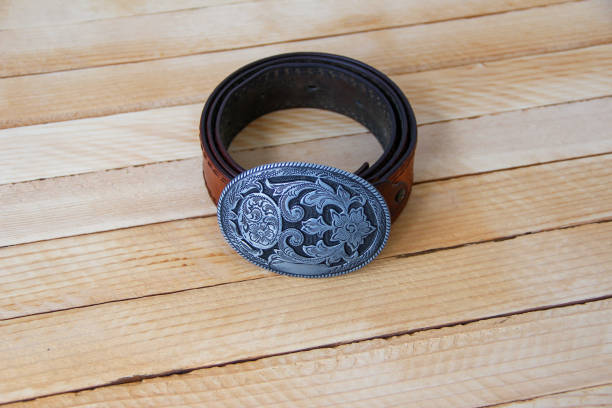 istock Leather cowboy belt on wooden background 1319968879