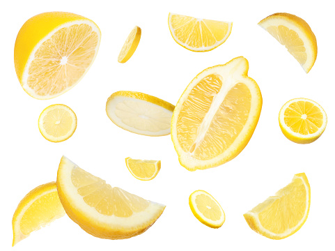 Fresh cut lemons flying on white background
