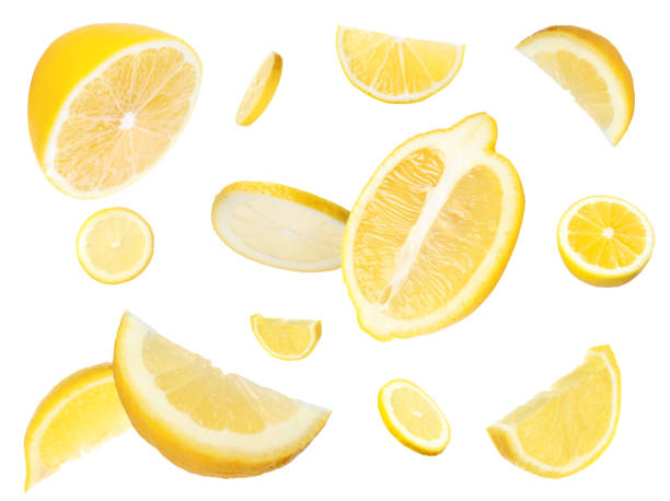 fresh cut lemons flying on white background - lemon imagens e fotografias de stock