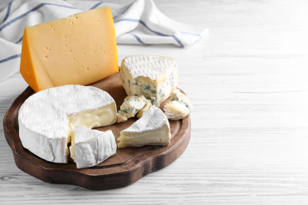 Gourmet cheese board offering various types of cheese, grapes, walnuts, and honey