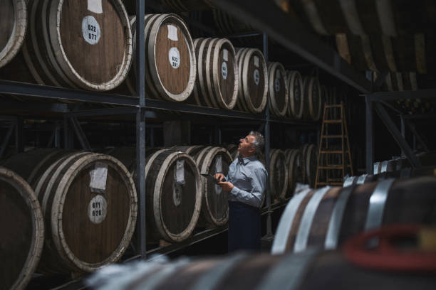 istock Examining barrels in aged cellar. 1319969125