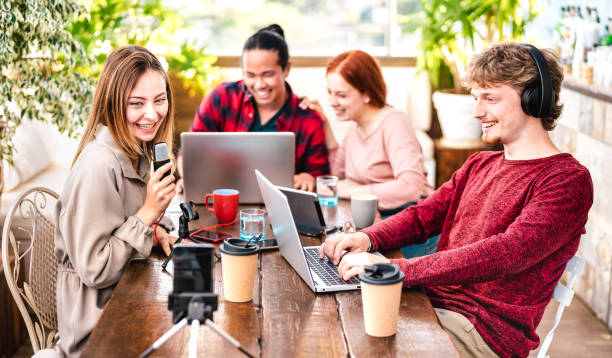 istock Happy people sharing content on streaming platforms with digital web cam - Modern life style concept with guys and girls speaking and having fun vlogging live feeds interview 1319973297