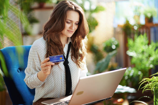 istock happy young woman using laptop at modern home in sunny day 1319975142