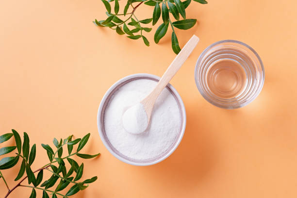 collagen powder and glass of water on bright background, top view - protein powder imagens e fotografias de stock