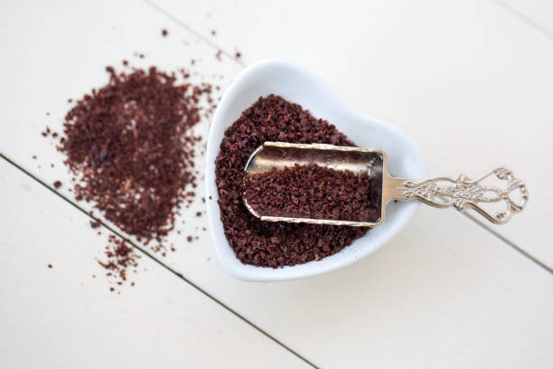 sumac sumac powder on white wooden background sumac spice stock pictures, royalty-free photos & images