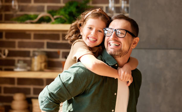 istock Young joyful father and daughter playing together at home 1319976875