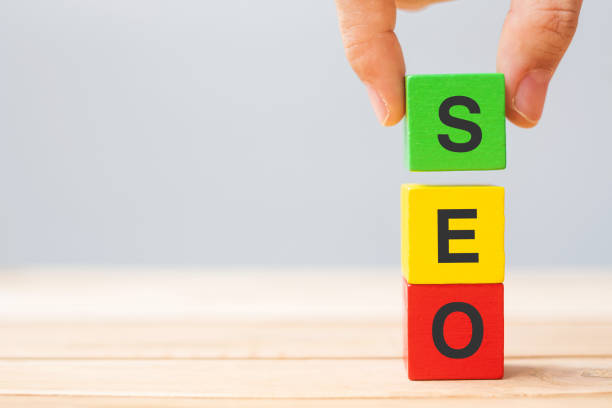 istock SEO (Search Engine Optimization) text wooden cube blocks on table background. Idea, Strategy, marketing, Keyword and Content concept 1319981675