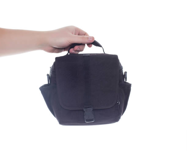 istock Man holding camera bag on white background, isolate. Close-up, photograph 1319981793