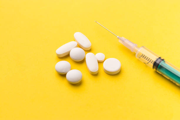 istock Syringe with medicine pill on textured background stock image. 1319986921