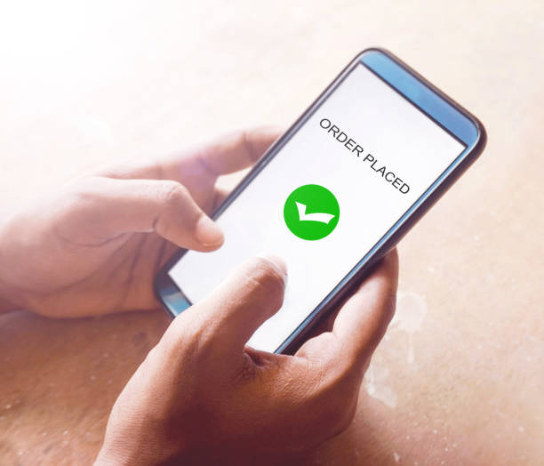 istock Order placed on a smartphone, hand holding smartphone 1319987479