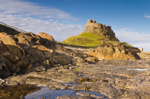 Lindisfarne Castle from the Rocks with rock pool in foreground