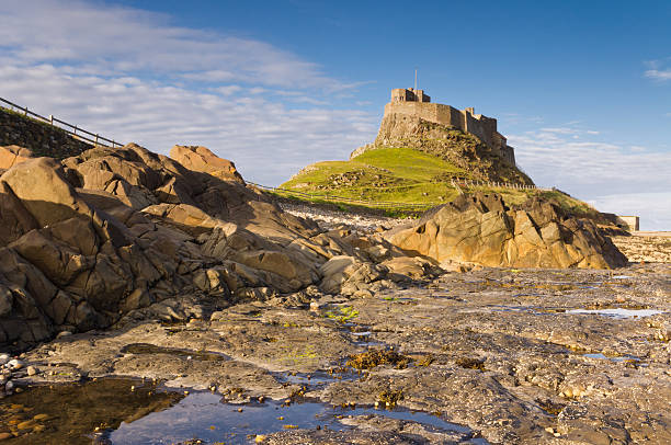 Lindisfarne Castle from the Rocks Lindisfarne Castle from the Rocks with rock pool in foreground northumberland stock pictures, royalty-free photos & images
