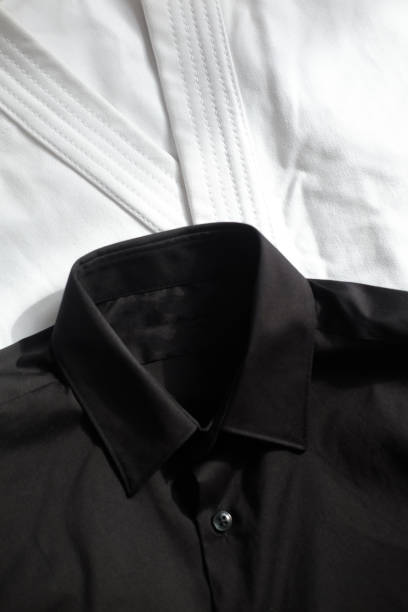 istock White kimono for karate training. Next to it is a black classic shirt 1319988079