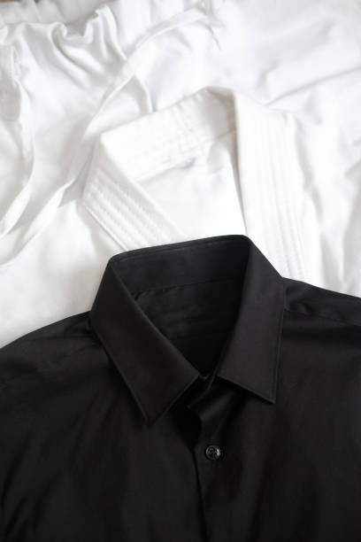istock White kimono for karate training. Next to it is a black classic shirt 1319988101