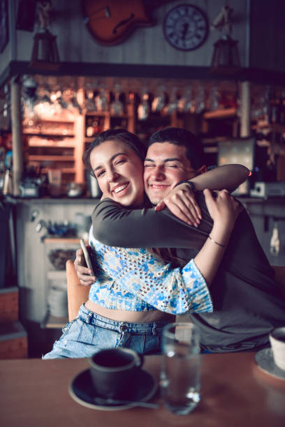 istock Smiling Couple Embracing While Enjoying Coffee In Bar 1319992535