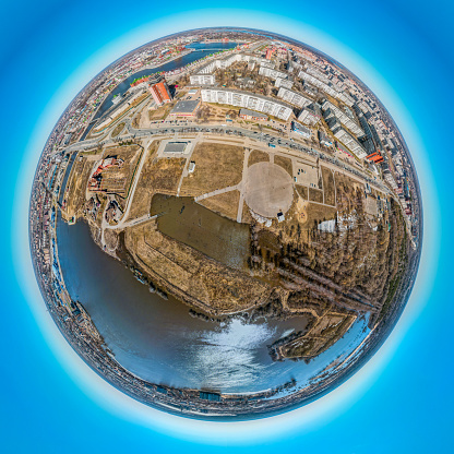 A round city skyline of the Yoshkar-Ola, the Volga region, Russia. The city center, the embankment and the residential districts during high water. A aerial view of a flood in a town, springtime, sunny day