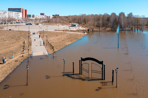 A city park and recreation area is under water at a spring flood. A aerial view of a flood in a town, springtime, sunny day. Yoshkar-Ola, Volga region, Russia