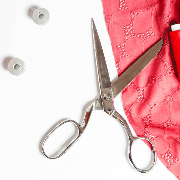 istock Tailoring. sewing accessories. scissors, cloth on a white background close-up 1319993952