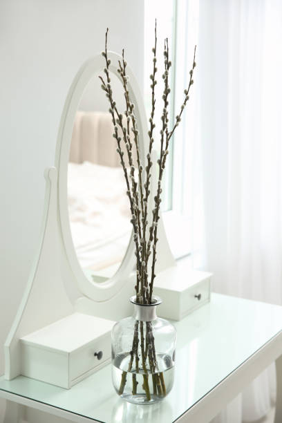 istock Beautiful blooming pussy willow branches on white dressing table indoors 1319994926