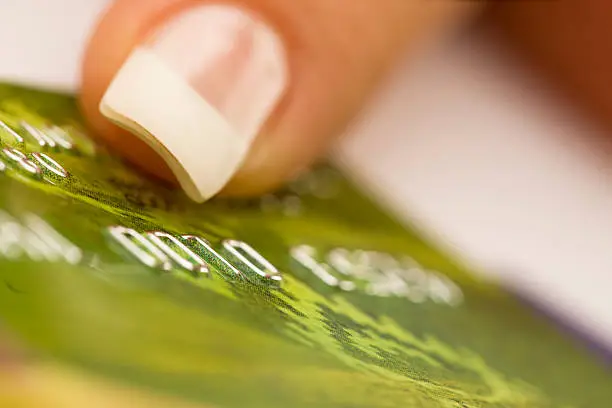 Woman holding green bankcard, close-up, canon 1Ds mark III