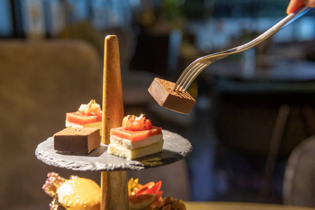 istock Fork picking up English afternoon tea desserts 1319997416