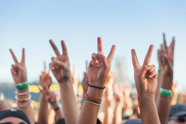istock Hands raised at a protest rally concert with peace signs 1319998123