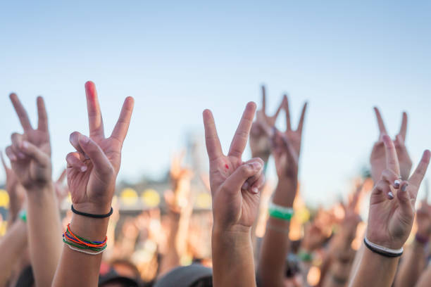 Ręce podniesione na koncercie protestacyjnym ze znakami pokoju – zdjęcie