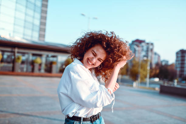 Female Beauty Putting Had In Hair While Walking Outside