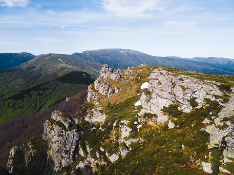 Landscape with mountains on a Sunny day. Babin Zub rock formation in Stara Planina (Old Mountains).  Nature outdoors travel destination, Serbia. Aerial, drone view