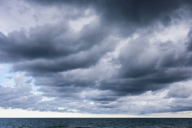 istock Dark dramatic sky and stormy clouds over the sea 1320002279